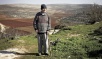 Israeli army preventing Palestinian from sowing land near settlement