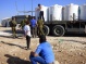 Israeli forces seize a tractor, its truck, four water tanks, and three bases from Susiya village