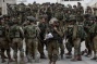 Israeli troops detain 18 in West Bank, raid homes