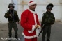 PHOTOS: Palestinian Santas protest the occupation in Bethlehem