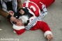 PHOTOS: Palestinian Santas protest the occupation in Bethlehem