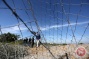 In video - Israeli forces detain youth after cutting off part of security fence